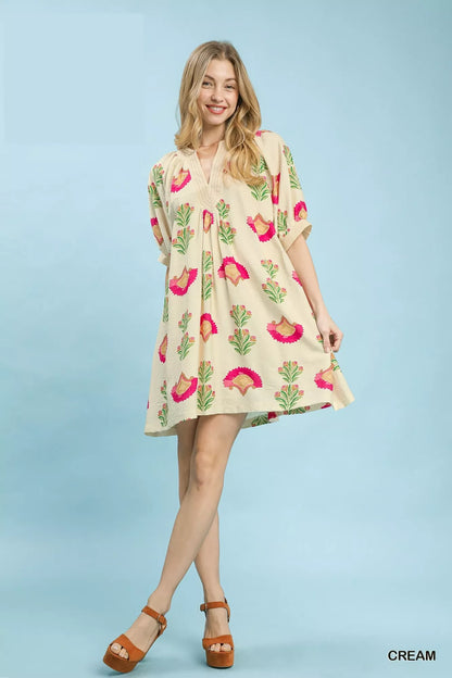Cream Umgee abstract print mini dress with long sleeves and flowy silhouette, perfect for casual or semi-formal occasions.