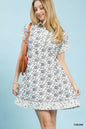 Cream Umgee border print belted shirt dress with long sleeves and a relaxed fit, styled for casual wear.