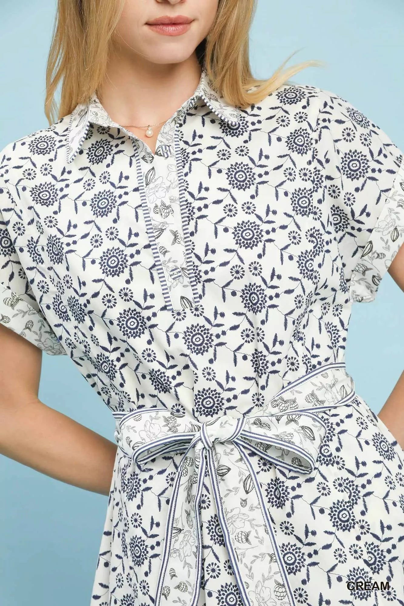Cream Umgee border print belted shirt dress with long sleeves and a relaxed fit, styled with a matching fabric belt.