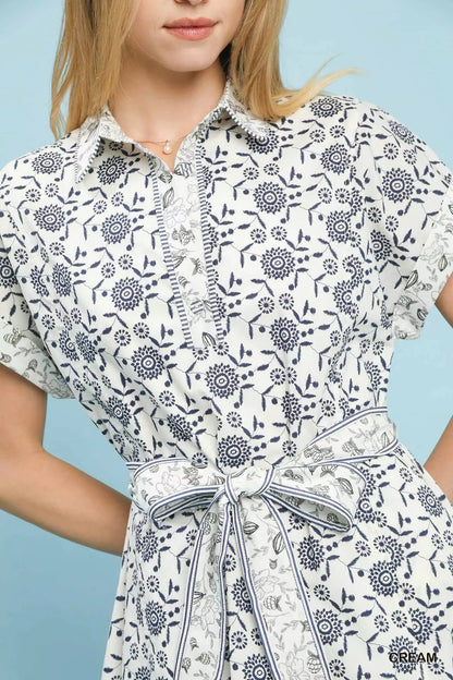 Cream Umgee border print belted shirt dress with long sleeves and a relaxed fit, styled with a matching fabric belt.