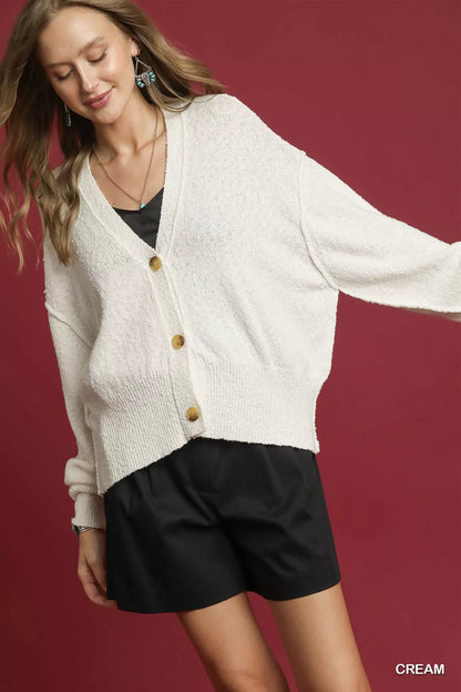 Cream Umgee button-front V-neck knit cardigan by Trendsi, shown on a model with long sleeves and a relaxed fit.