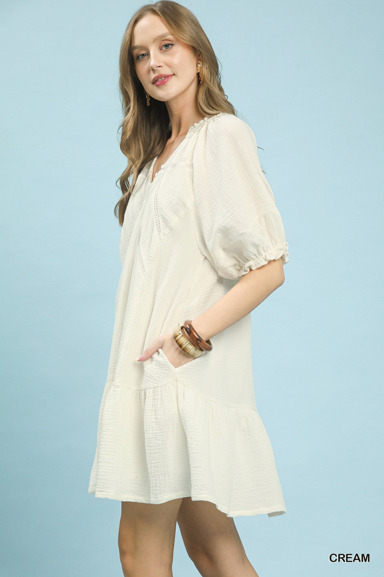 Cream Umgee cotton gauze mini dress with short sleeves and relaxed fit, styled with a V-neck and lightweight breathable fabric.
