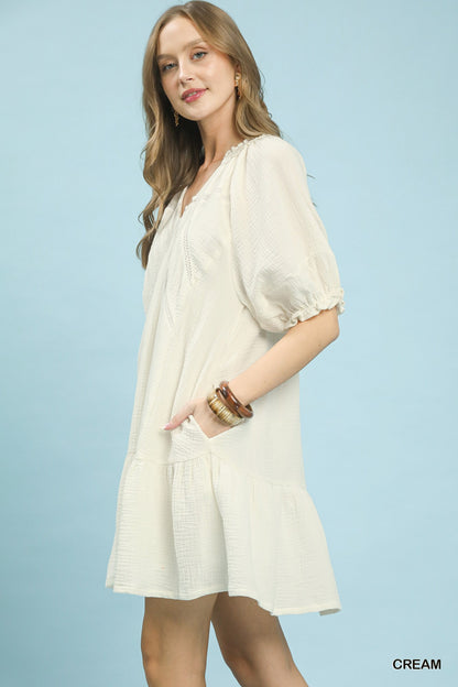 Cream Umgee cotton gauze mini dress with short sleeves and relaxed fit, styled with a V-neck and lightweight breathable fabric.