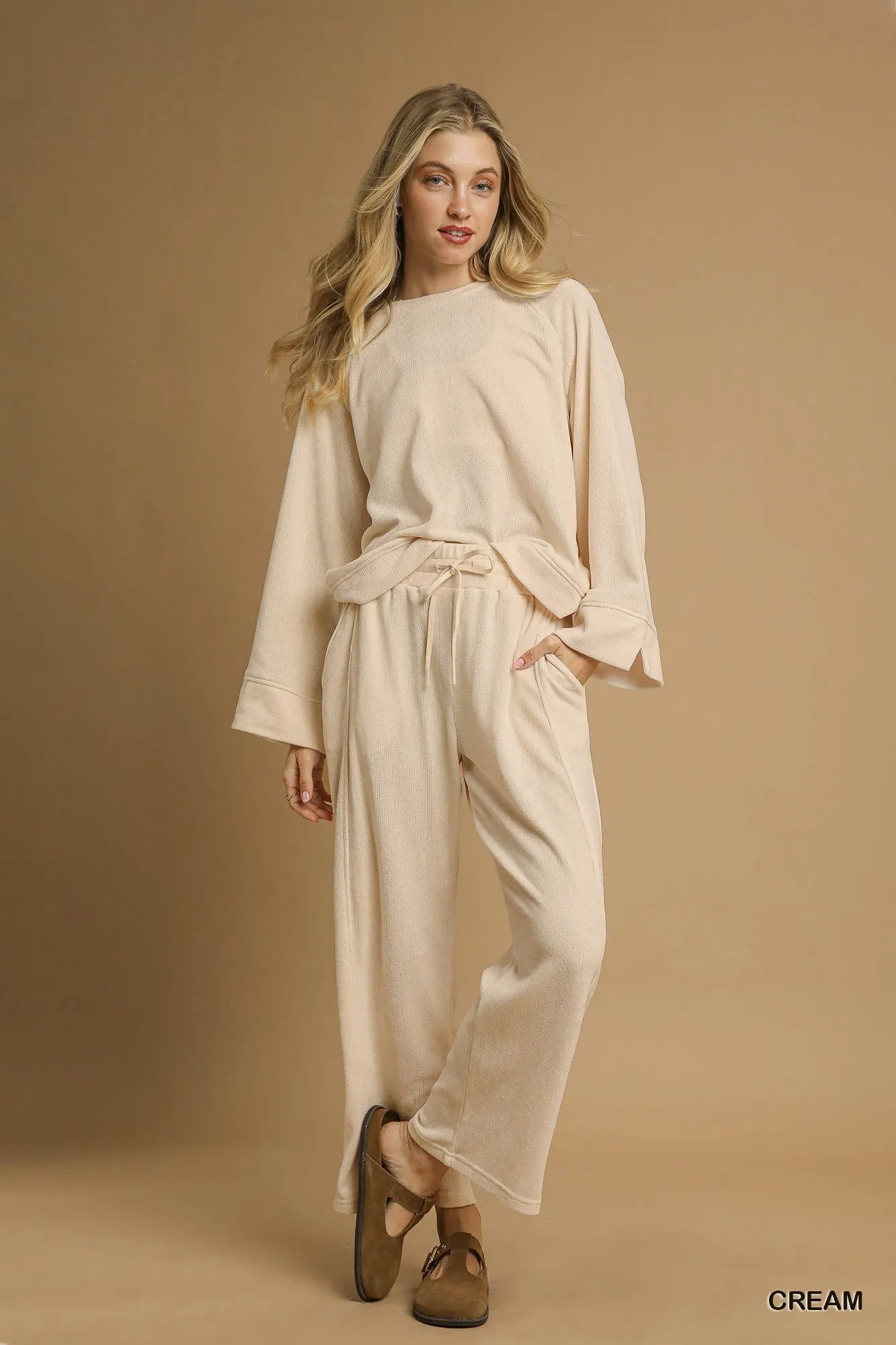 Cream Umgee drawstring wide-leg pants from Trendsi, featuring a relaxed fit and comfortable waistband.