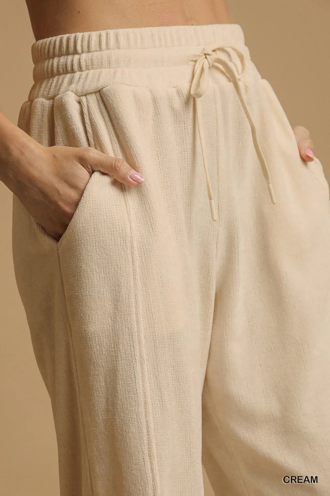 Cream Umgee drawstring wide-leg pants by Trendsi, featuring a relaxed fit and comfortable waistband, displayed on a neutral background.