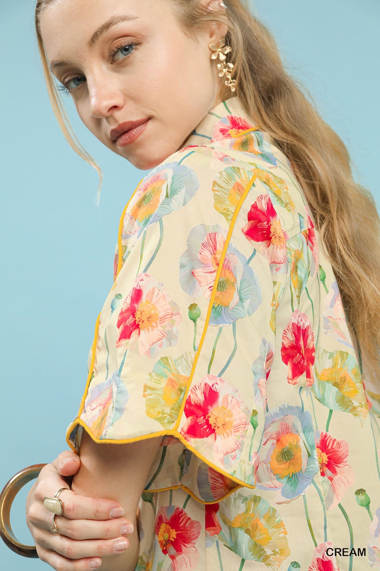 Cream floral print Umgee button-down blouse with flutter sleeves, featuring a relaxed fit and feminine design.