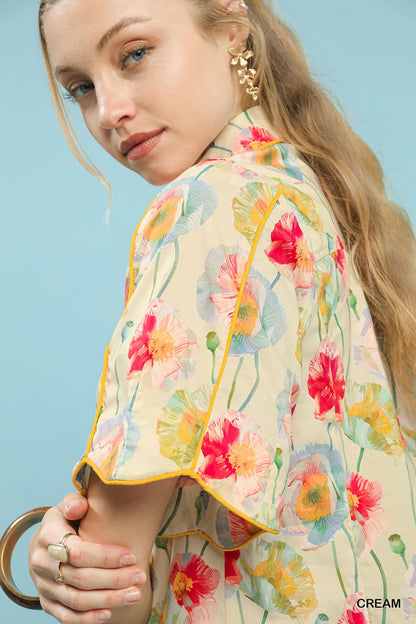 Cream floral print Umgee button-down blouse with flutter sleeves, featuring a relaxed fit and feminine design.