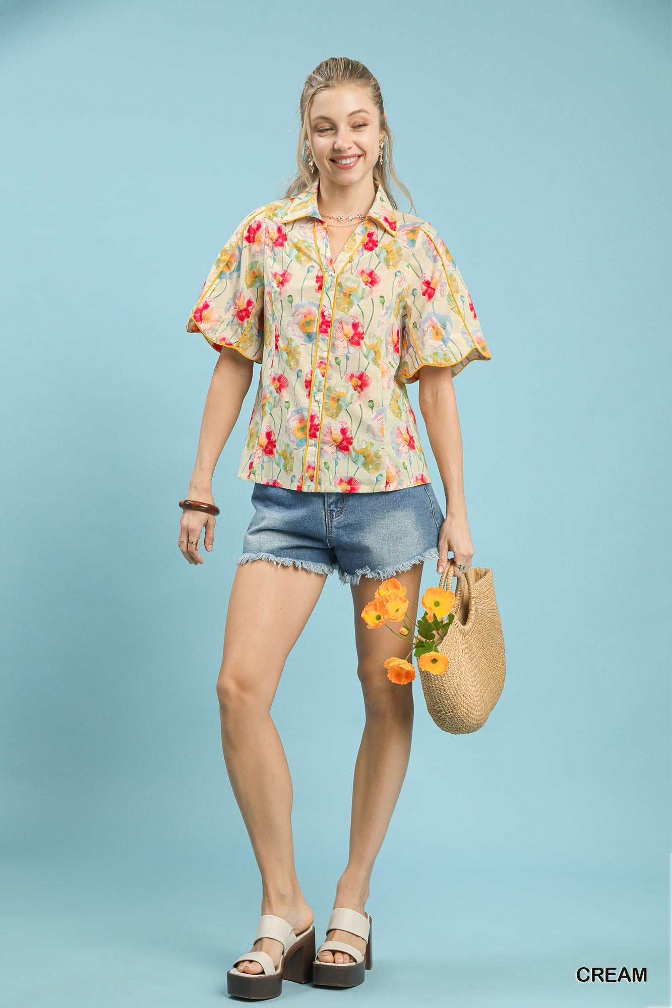 Cream floral print button-down blouse by Umgee featuring flutter sleeves, styled with a relaxed fit and feminine design.