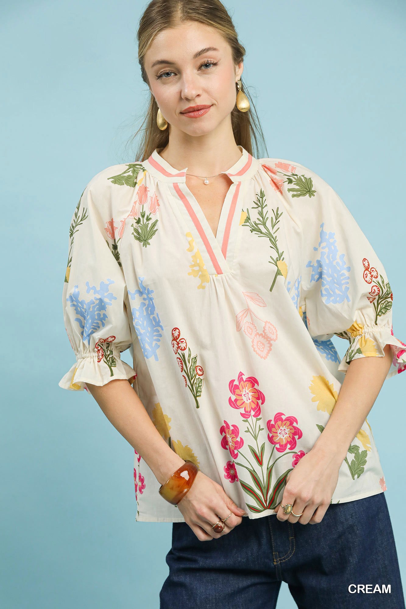 Cream floral split neck puff sleeve top by Umgee featuring a feminine design and ruffled details, perfect for casual or dressy wear.