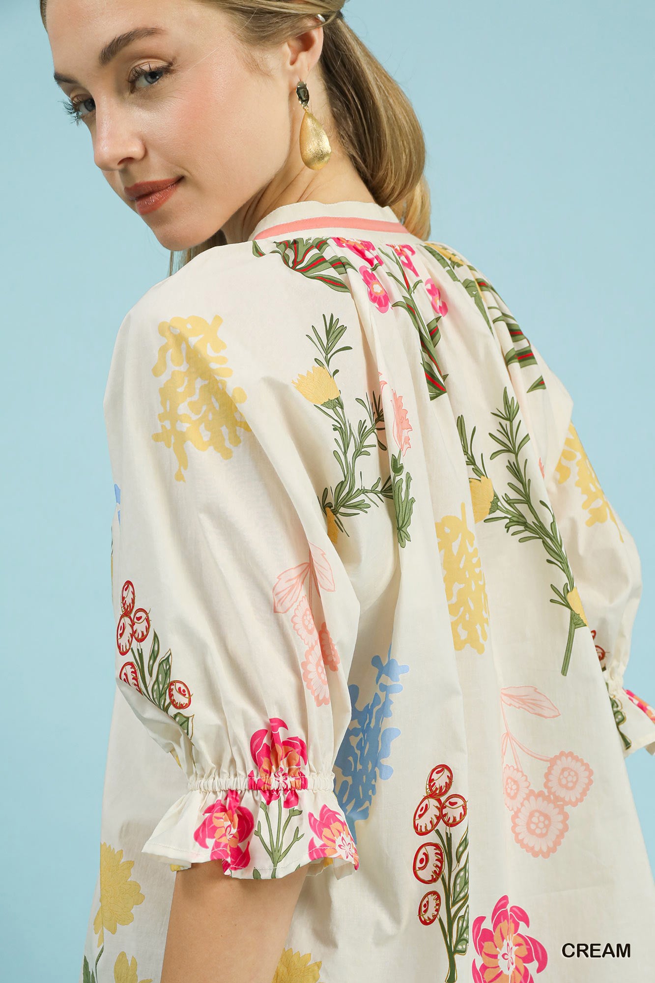 Cream floral split-neck puff sleeve top by Umgee featuring a relaxed fit and feminine design, perfect for casual or dressy occasions.