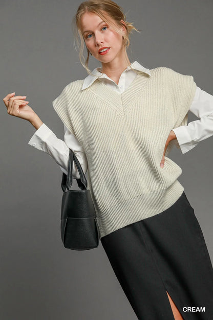 Cream-colored Umgee oversized V-neck vest by Trendsi, featuring a relaxed fit and soft knit fabric, shown on a model.