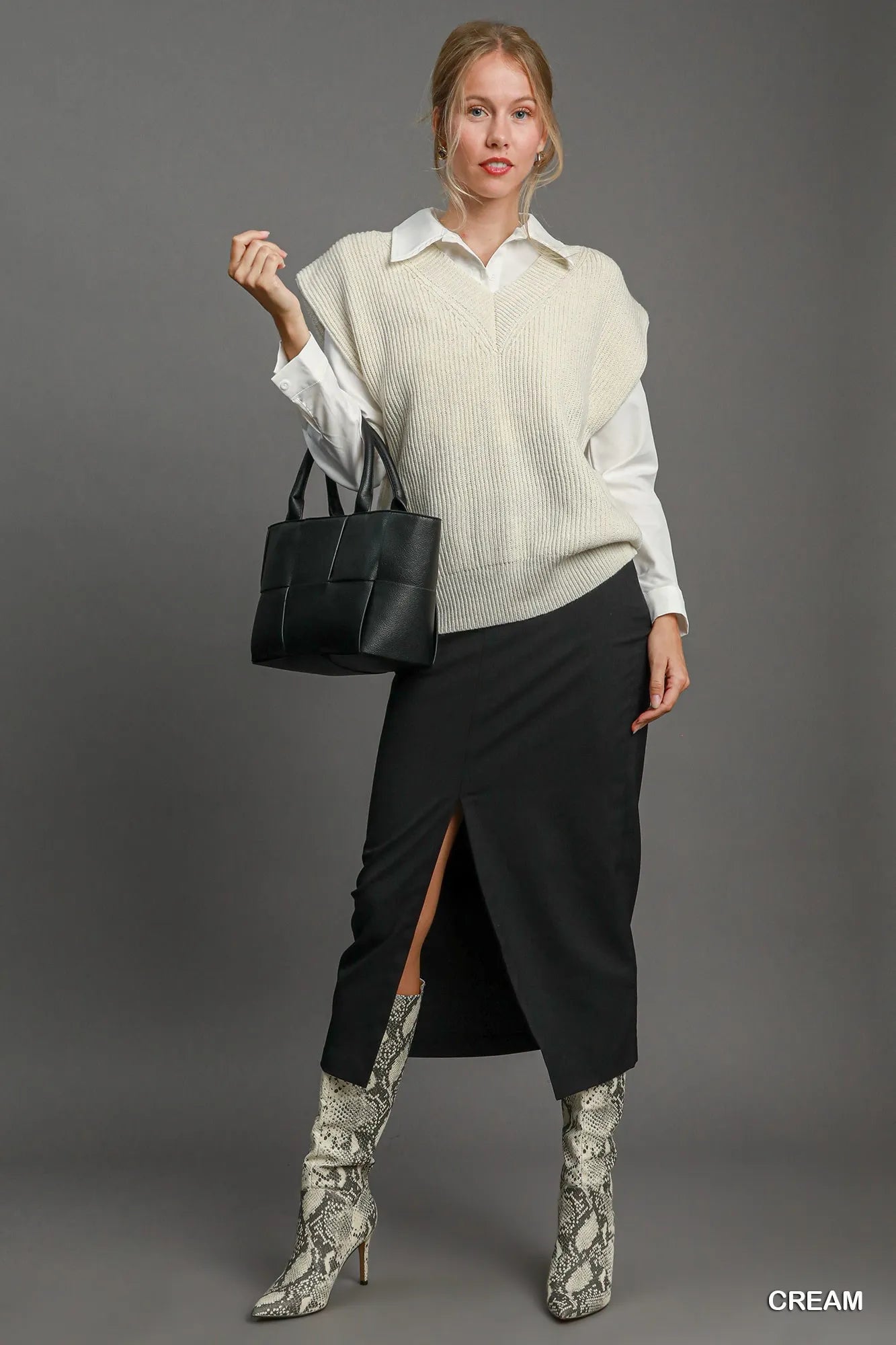 Cream-colored Umgee oversized V-neck vest from Trendsi, featuring a relaxed fit and soft knit fabric.