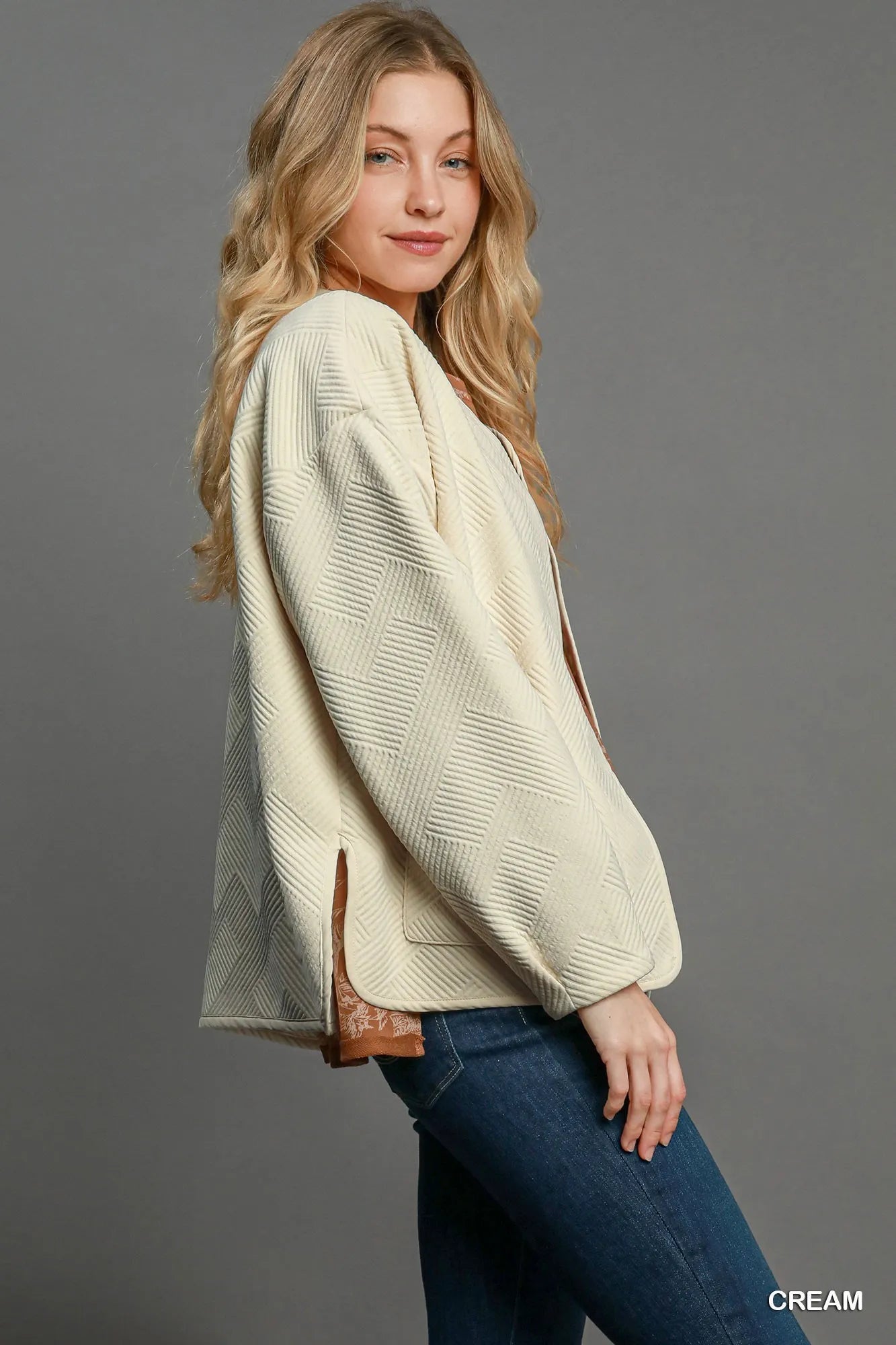Cream Umgee textured jacquard jacket with long sleeves and button front, styled on a model.