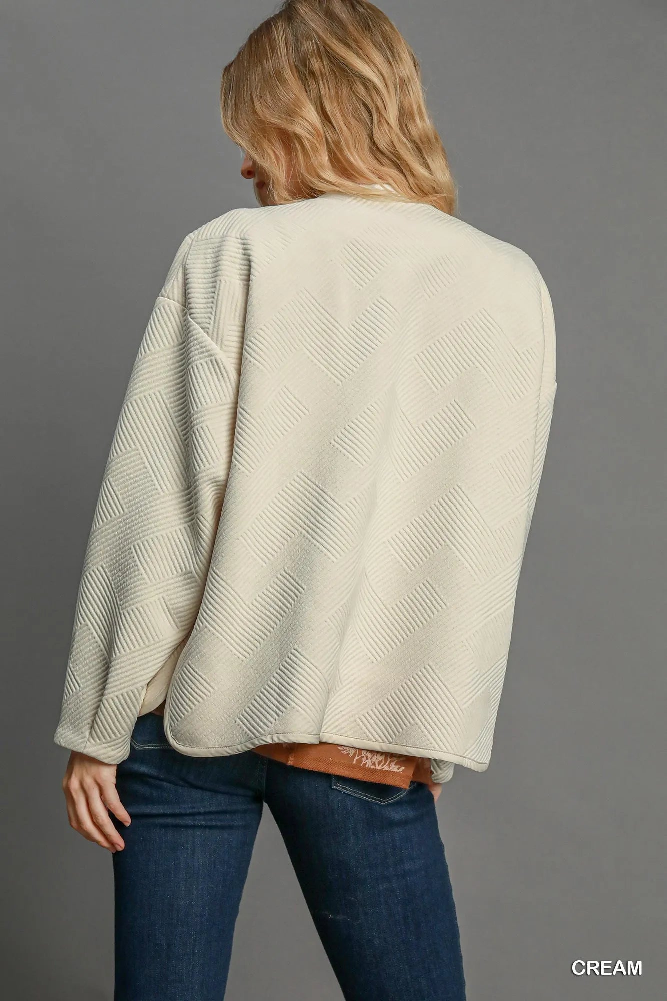 Cream Umgee Textured Jacquard Jacket with intricate woven pattern, featuring a stylish, structured design and long sleeves.