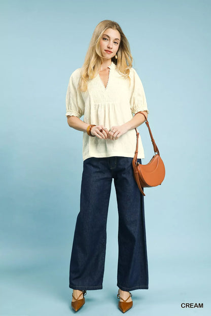Cream Umgee textured smocked peasant top with long sleeves and a relaxed fit, styled for casual or boho looks.