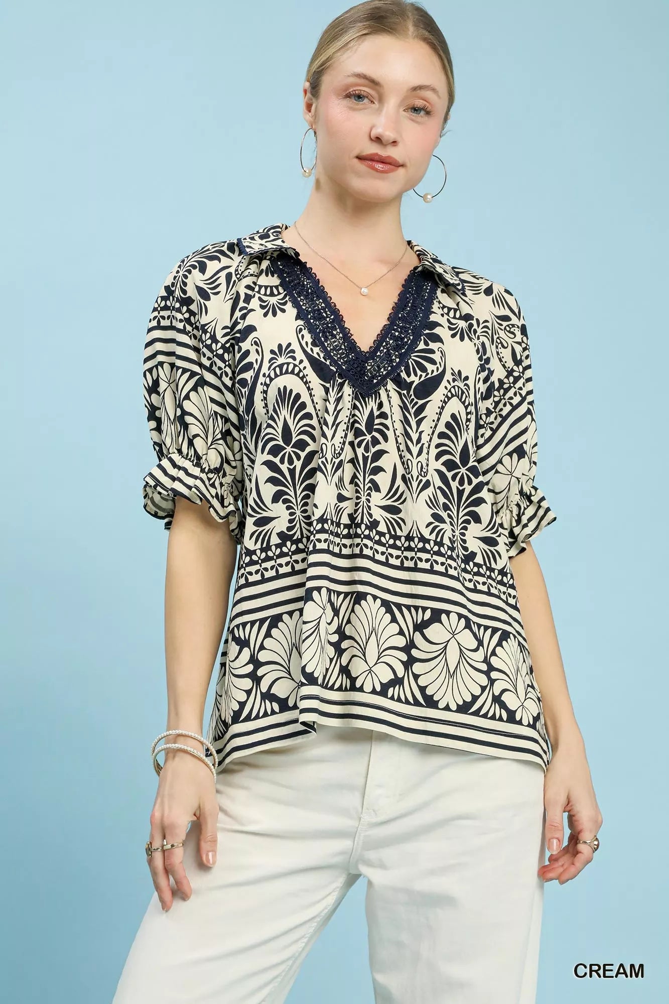 Cream Umgee two-tone border print top featuring a relaxed fit and stylish design, perfect for casual wear.