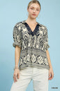 Cream Umgee two-tone border print top featuring a relaxed fit and stylish design, perfect for casual wear.