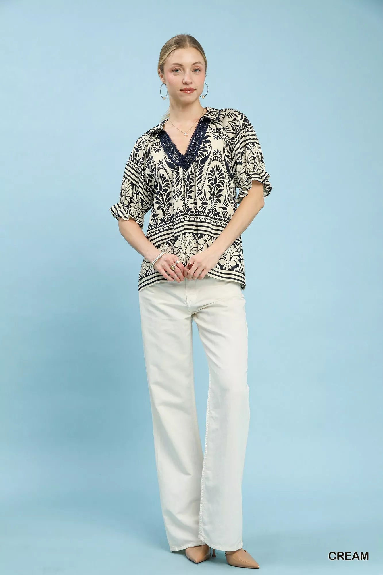 Cream Umgee two-tone border print top with long sleeves and relaxed fit, featuring a stylish, casual design.