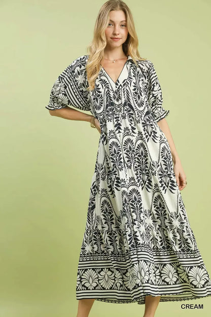 Cream Umgee two-tone border print midi dress with short sleeves and flowing silhouette, perfect for casual or semi-formal wear.