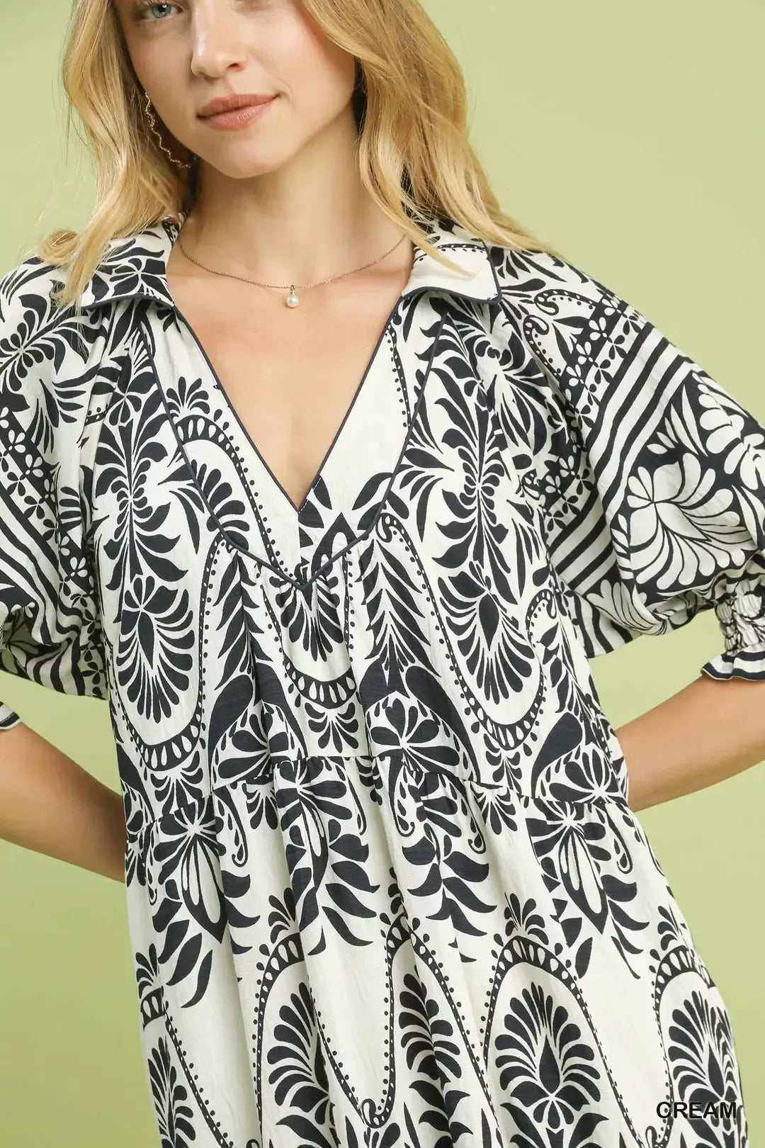 Cream Umgee two-tone border print midi dress featuring a relaxed fit and stylish design, perfect for casual or semi-formal wear.