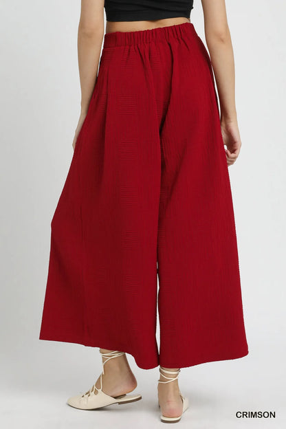 Crimson Umgee wide-leg pants with elastic waist and relaxed fit, styled for casual or chic outfits.