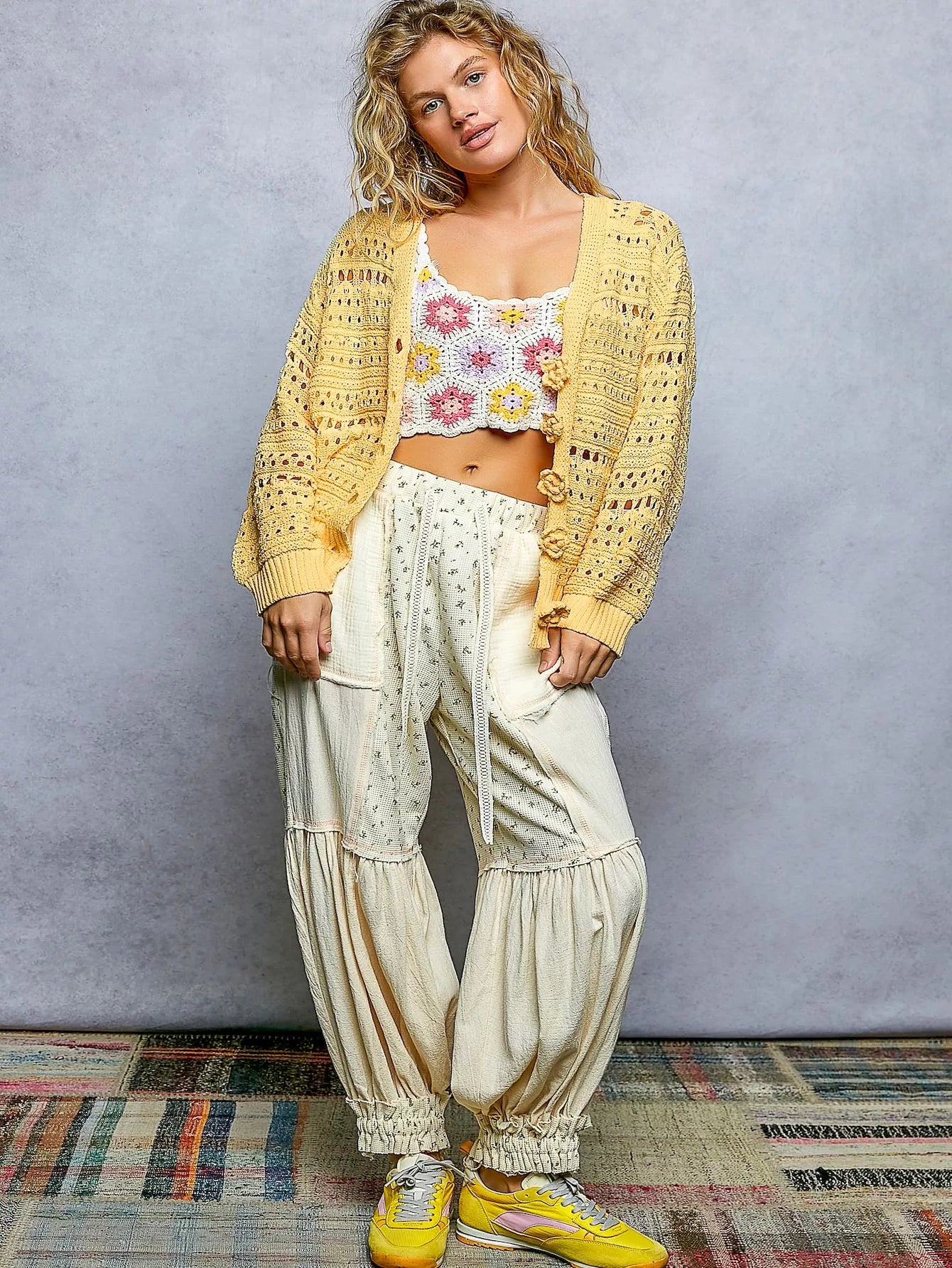 Open-knit floral button cardigan from Trendsi with a lightweight design, featuring colorful floral patterns and a relaxed fit.