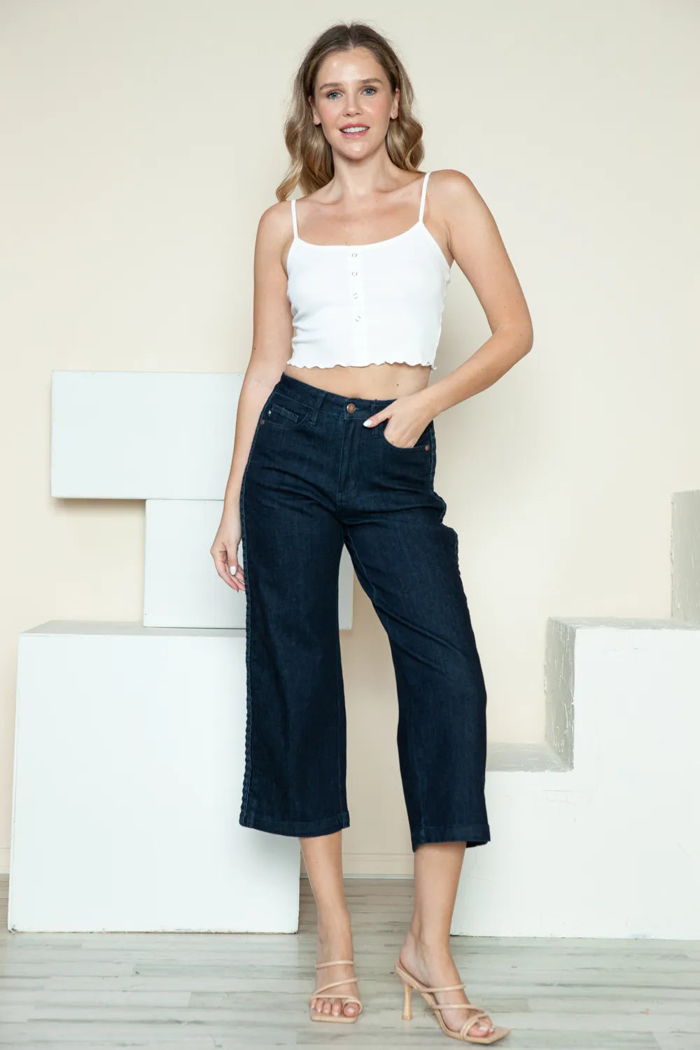 Dark Judy Blue crop wide leg jeans with side seam braid detail and high-rise fit, showcasing a stylish and trendy denim look.