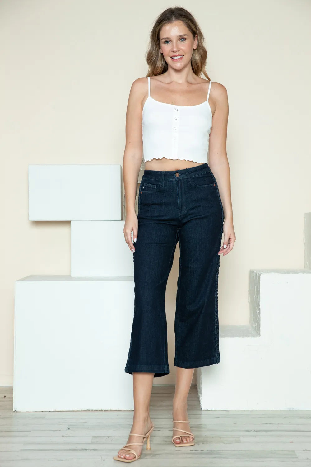 Dark wash Judy Blue full-size wide-leg jeans with side seam braid detail and cropped style, showcasing trendy denim fashion.