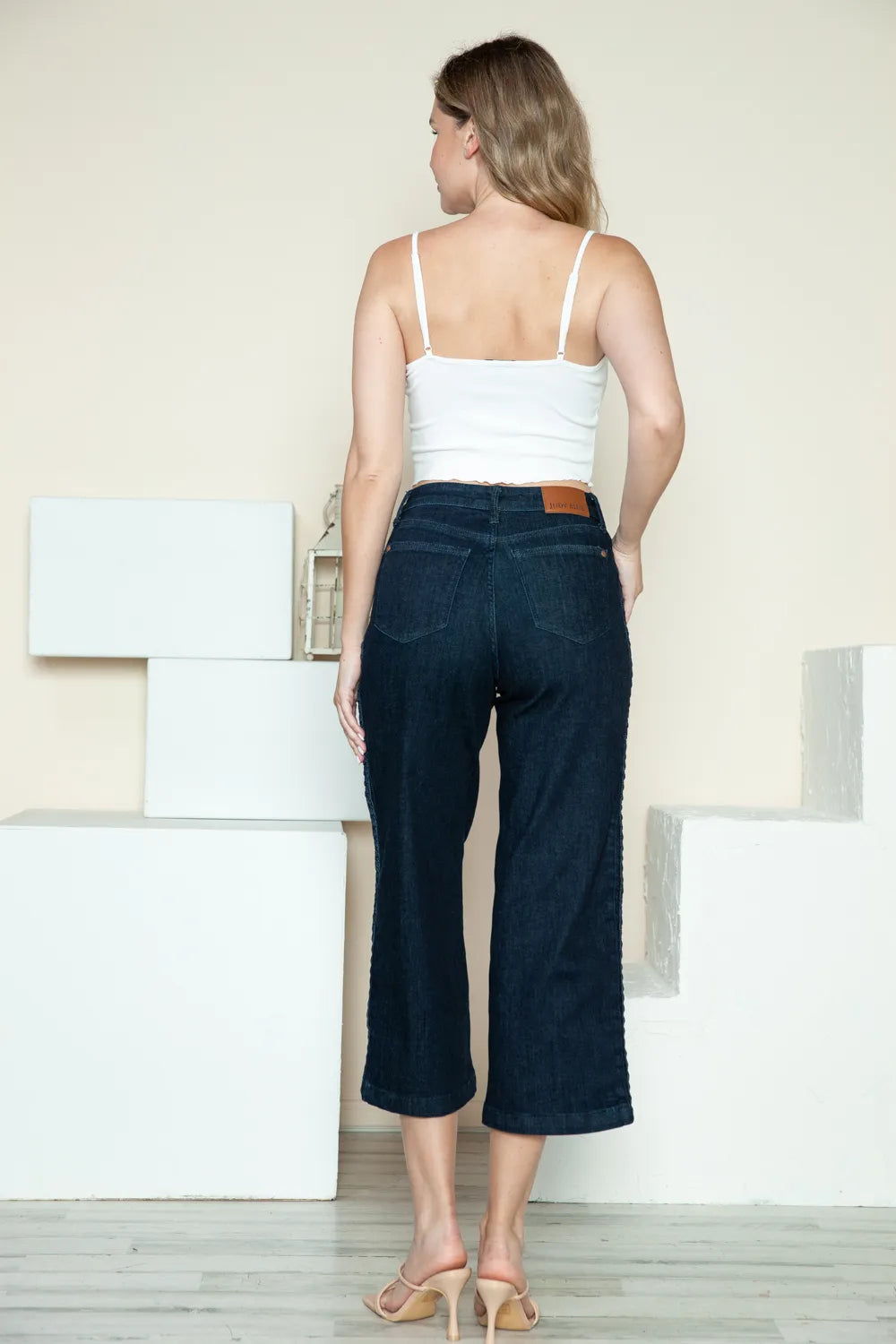 Dark Judy Blue high-waisted wide-leg jeans with side seam braid detail and cropped length, stylish and comfortable for casual wear.