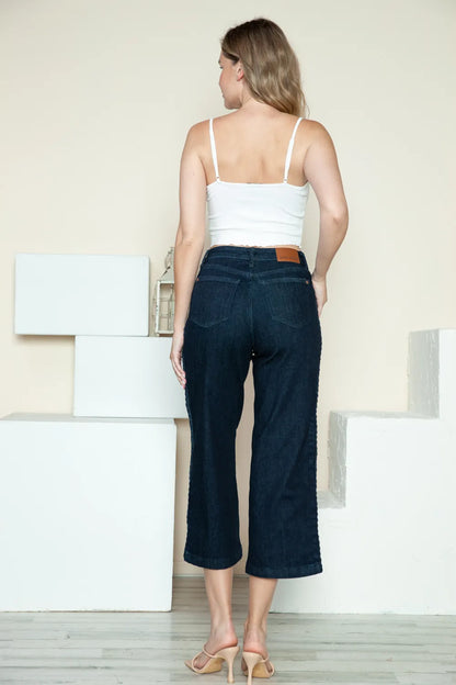 Dark Judy Blue high-waisted wide-leg jeans with side seam braid detail and cropped length, stylish and comfortable for casual wear.