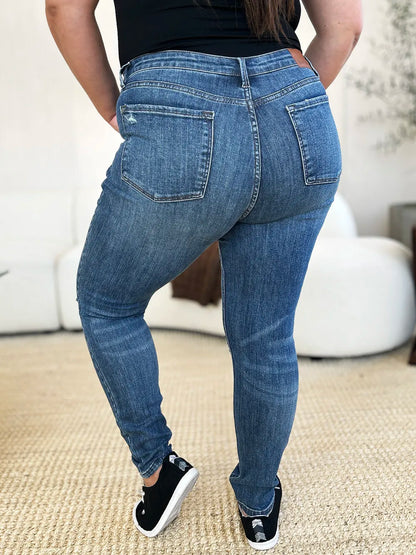 Dark Judy Blue full-size mid-waist distressed slim jeans with ripped detailing, showcasing a snug fit and trendy design.