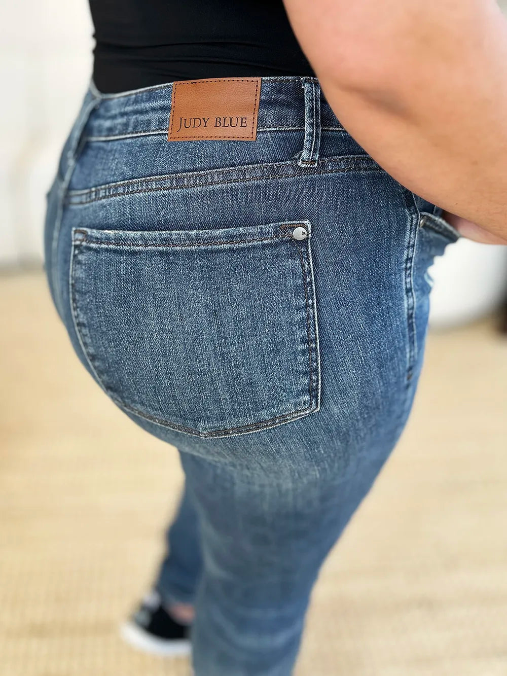 Dark Judy Blue full size mid-waist distressed slim jeans with fading and ripped details, shown on a model.
