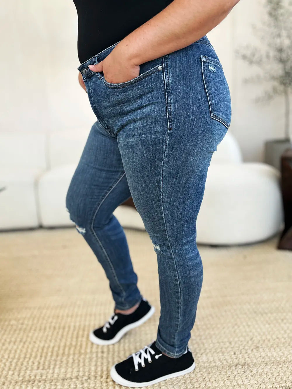 Dark wash Judy Blue full-size mid-rise distressed slim jeans with rips and fading, styled for a casual look.