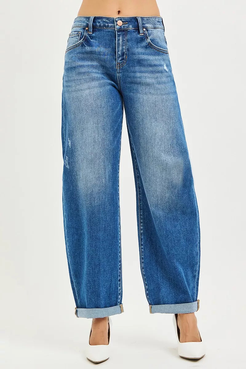 Dark blue Risen plus size mid-rise barrel jeans with double roll-up cuffs, styled for a casual look.