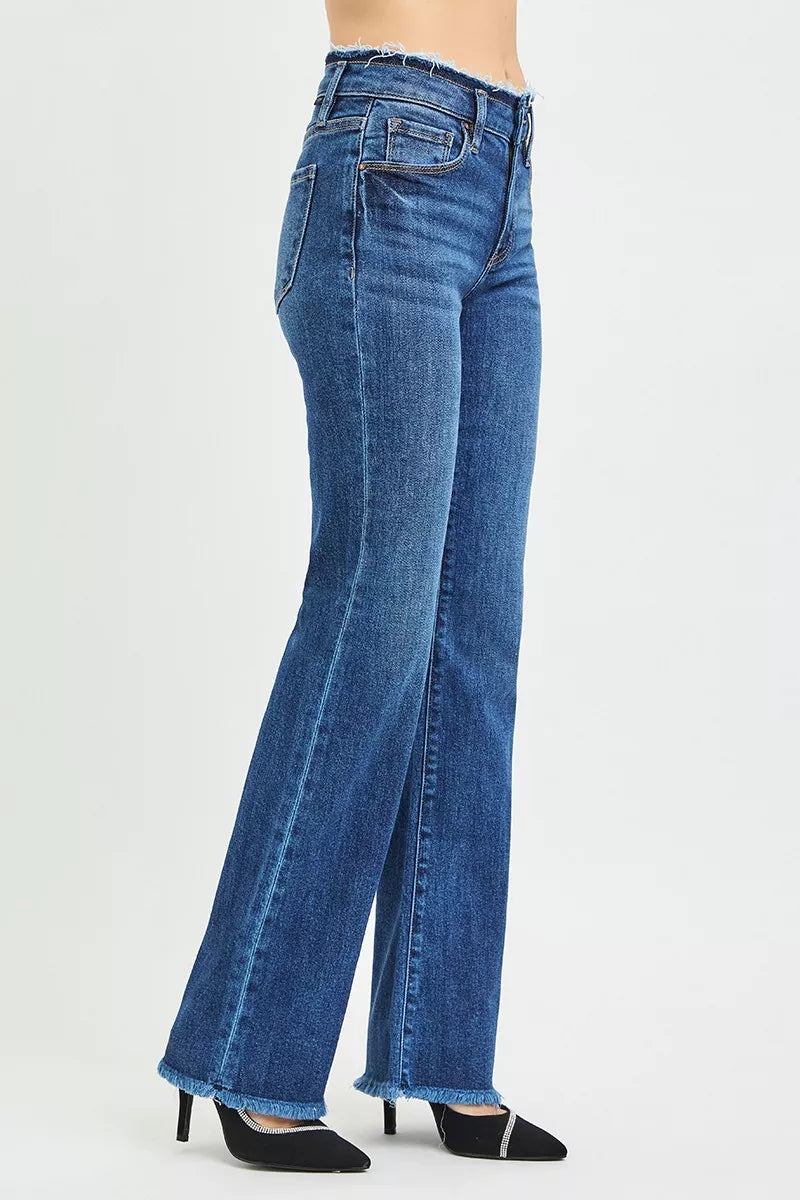 Dark wash plus size RISEN full size mid-rise bootcut jeans with frayed waistband and hem detail, styled by Trendsi.