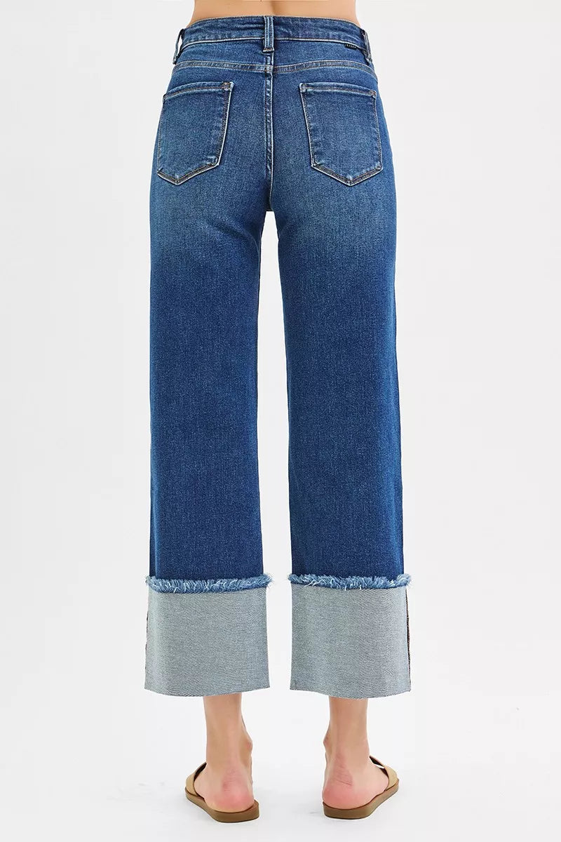 Dark wash Risen full size mid-rise crop wide cuffed jeans by Trendsi, featuring a relaxed fit and wide cuffed hem for plus size.