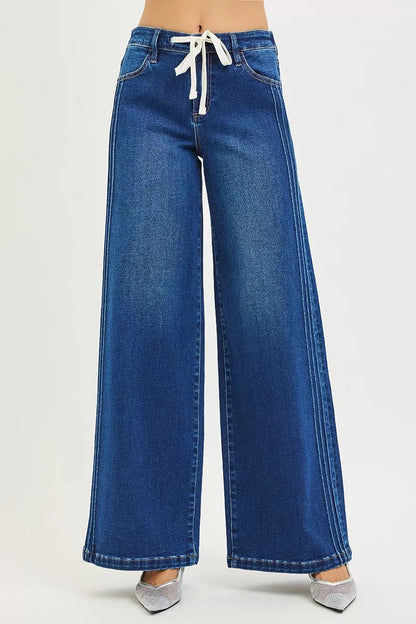Dark blue RISEN full-size mid-rise wide-leg jeans with side pintucks and front drawstring, plus size, by Trendsi.