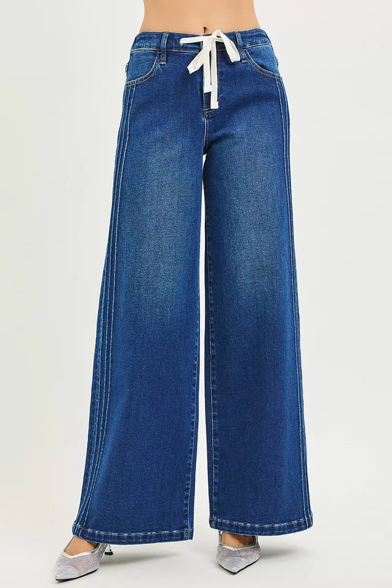 Dark blue Risen full-size mid-rise wide-leg pintuck jeans with front drawstring, plus size, by Trendsi, shown on a model.
