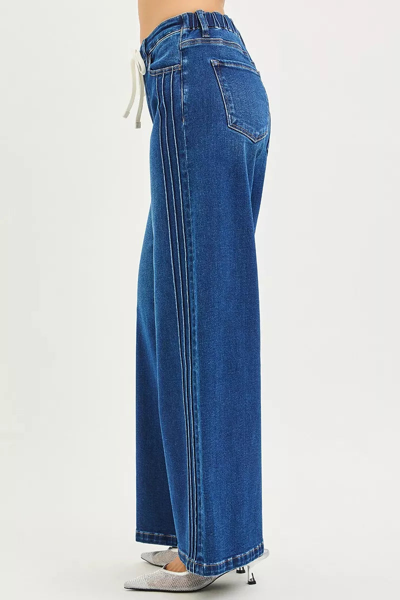 Dark denim RISEN full-size mid-rise wide-leg jeans with pintucks and front drawstring, plus size, by Trendsi.