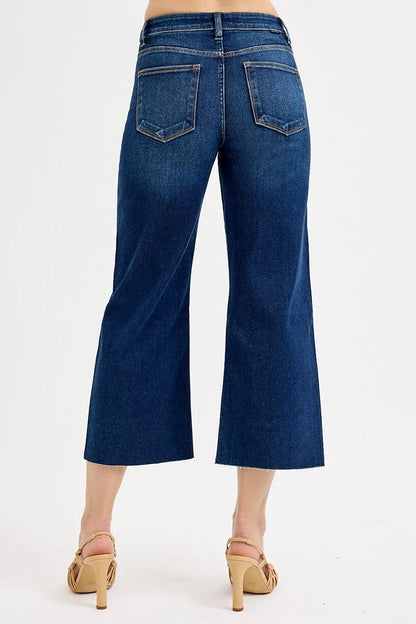 Dark wash RISEN plus size high-rise crop wide jeans with tummy control and full size fit, styled for a comfortable, flattering look.