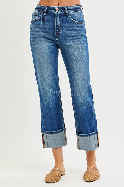 Dark blue Risen high-rise straight jeans with distressed hem, showcasing a fashionable fit and stylish distressed details.