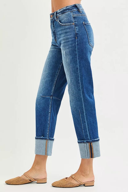 Dark blue RISEN high-rise straight jeans with distressed hem, showcasing a modern casual fit and stylish denim design.