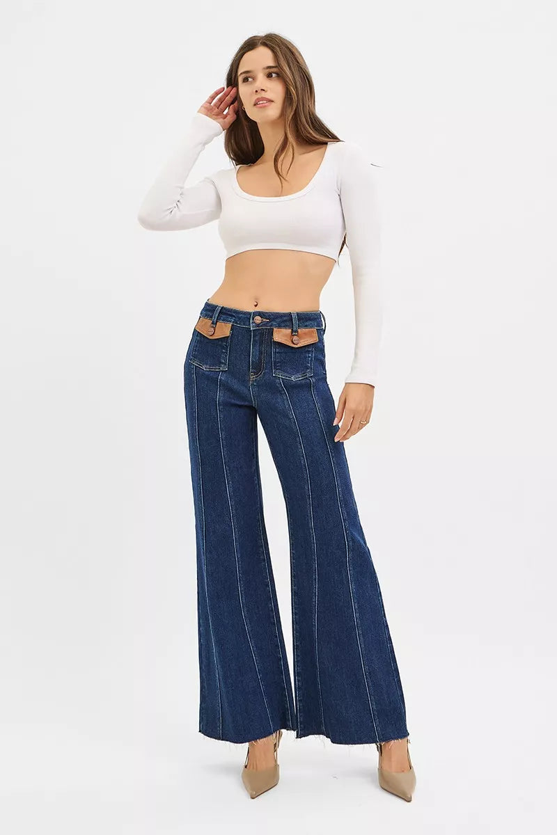 Dark Risen high-rise wide flare jeans with front leather pocket detail, showcasing stylish denim and unique pocket accents.
