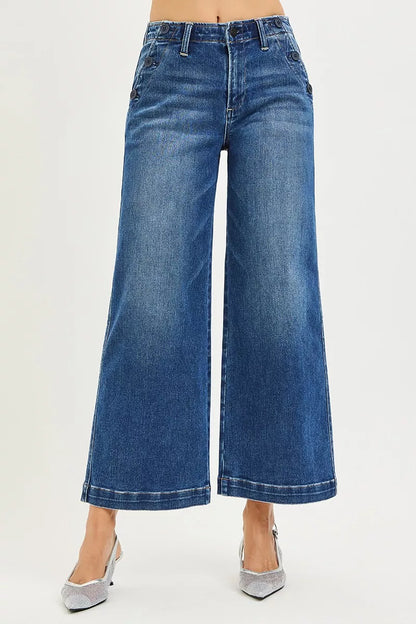 Dark wash Risen high-rise wide-leg jeans by Trendsi with front pockets and button details, styled on a model.