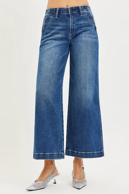 Dark wash Risen high-rise wide-leg jeans by Trendsi with front pockets and button detail, styled with a casual look.