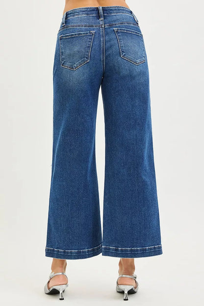 Dark high-rise wide-leg jeans by Risen with pocket and button details, styled with a casual, relaxed fit.
