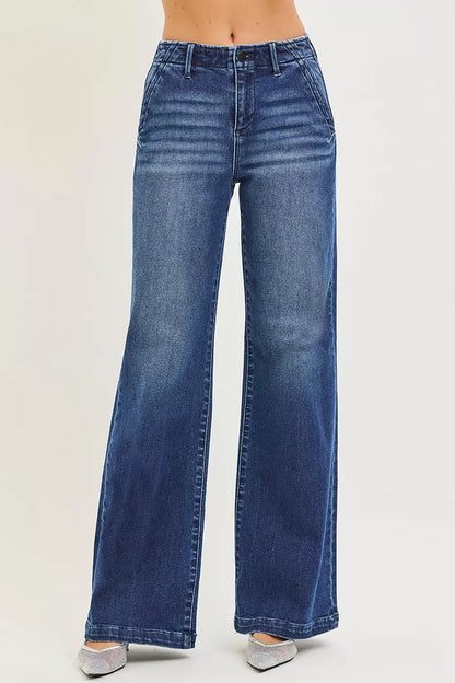 Dark wash RISEN high-rise wide-leg jeans with slanted pockets, styled with a relaxed fit and contemporary design.
