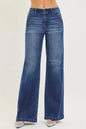 Dark wash RISEN high-rise wide-leg jeans with slanted pockets, styled with a relaxed fit and contemporary design.