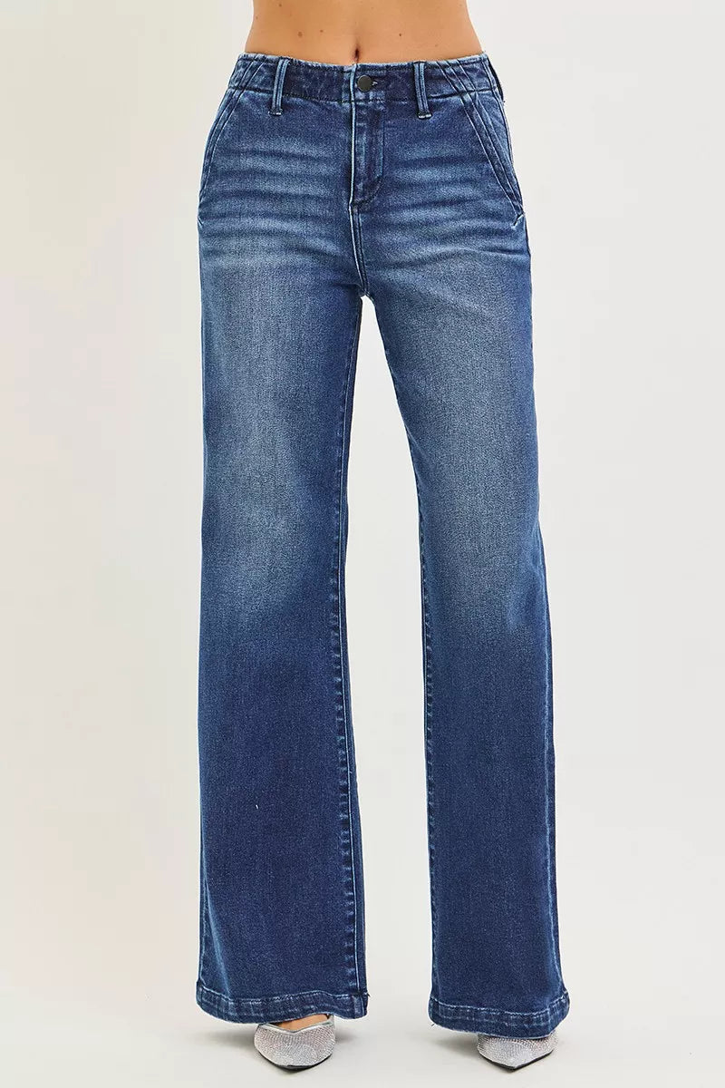 Dark wash RISEN high-rise wide-leg jeans with slanted pockets, featuring a trendy relaxed fit and stylish denim detail.