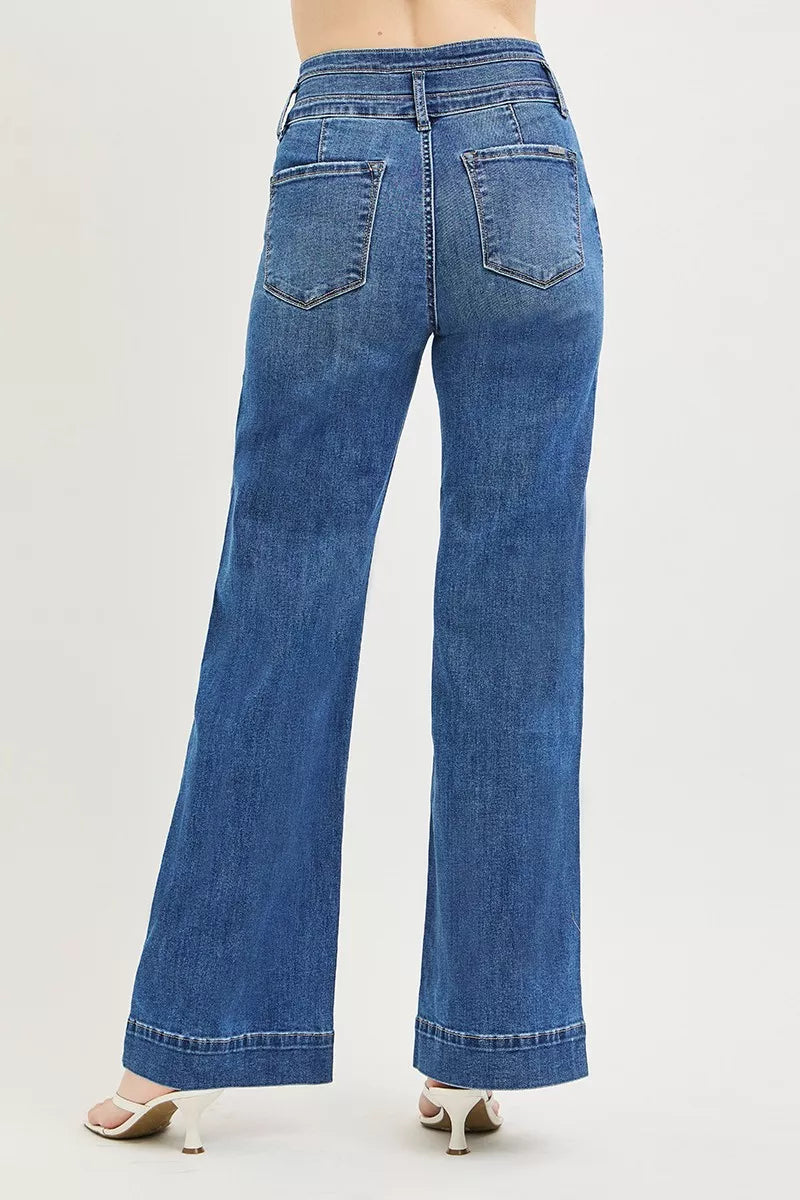 Dark wash RISEN high-rise wide-leg jeans with wide band detail, displayed on a hanger. Trendy denim with a relaxed fit.
